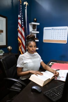 A Woman in White Shirt Sitting on Black Rolling Chair